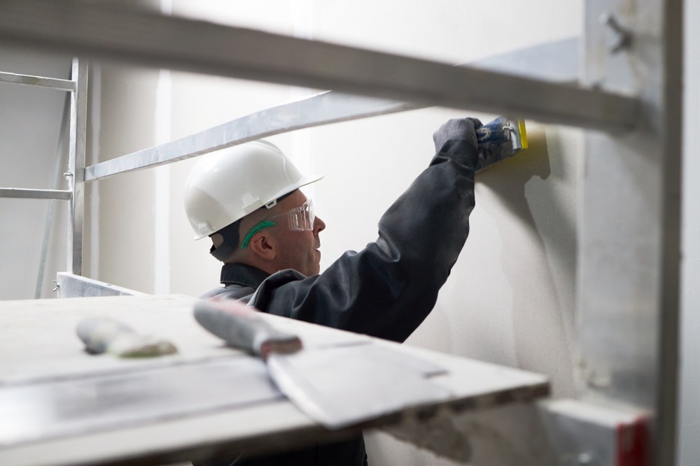 man puttying wall at construction site 2025 06 05 23 29 10 utc