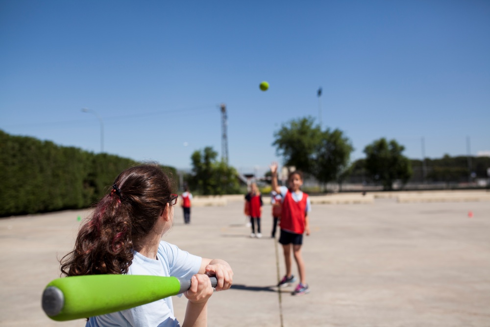 girls playing baseball wiffle ball