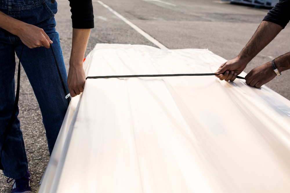 man and woman securing wood paneling package with 2024 10 17 23 45 44 utc